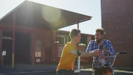 BMX-riders-sitting-in-a-yard-talking