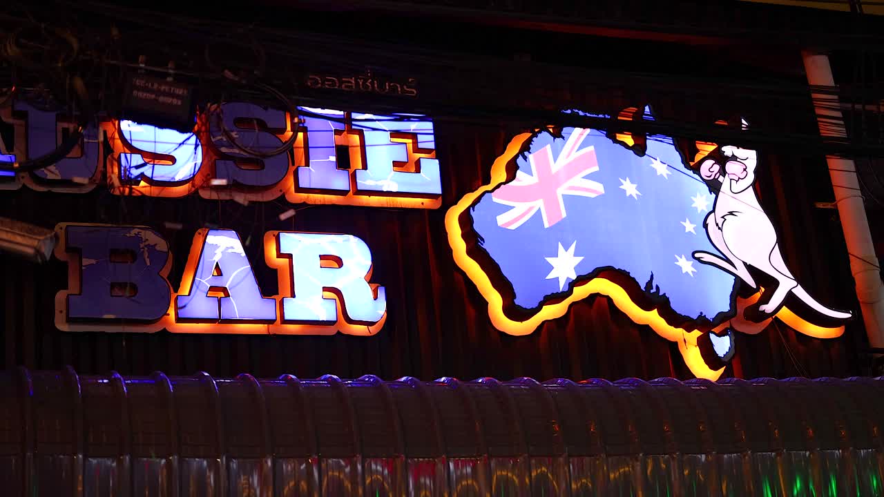Bright neon sign animation of Aussie Bar on Bangla Walking Street, Phuket. Vibrant colors and dynamic lighting create a lively atmosphere
