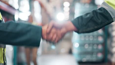 business handshake in a warehouse