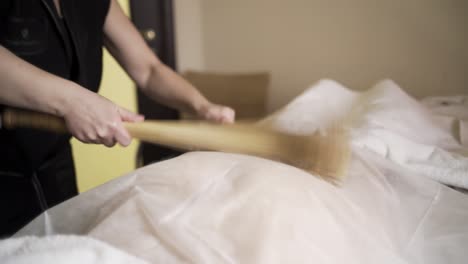 woman receiving a traditional body scrub massage