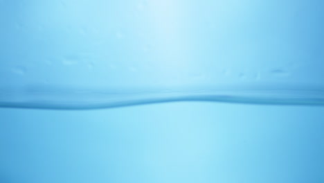 Water-waves-on-surface-with-blue-background