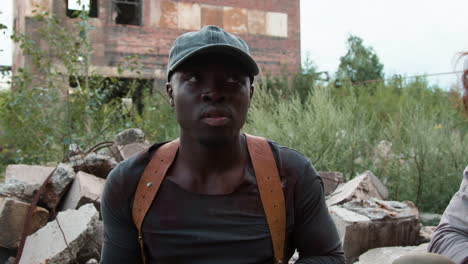 men guarding an abandoned building