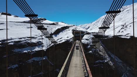 drone fly above asia's highest chicham bridge in spiti himachal pradesh india with himalayan mountains landscape covered in snow