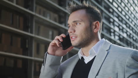 businessman talking on mobile phone at street