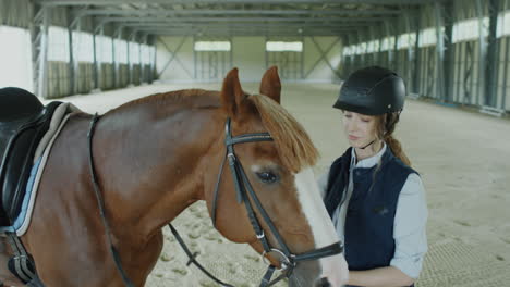 female rider checking bridle on horse
