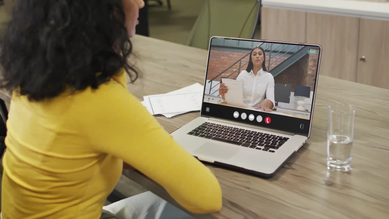 Animation of biracial woman having video call on laptop