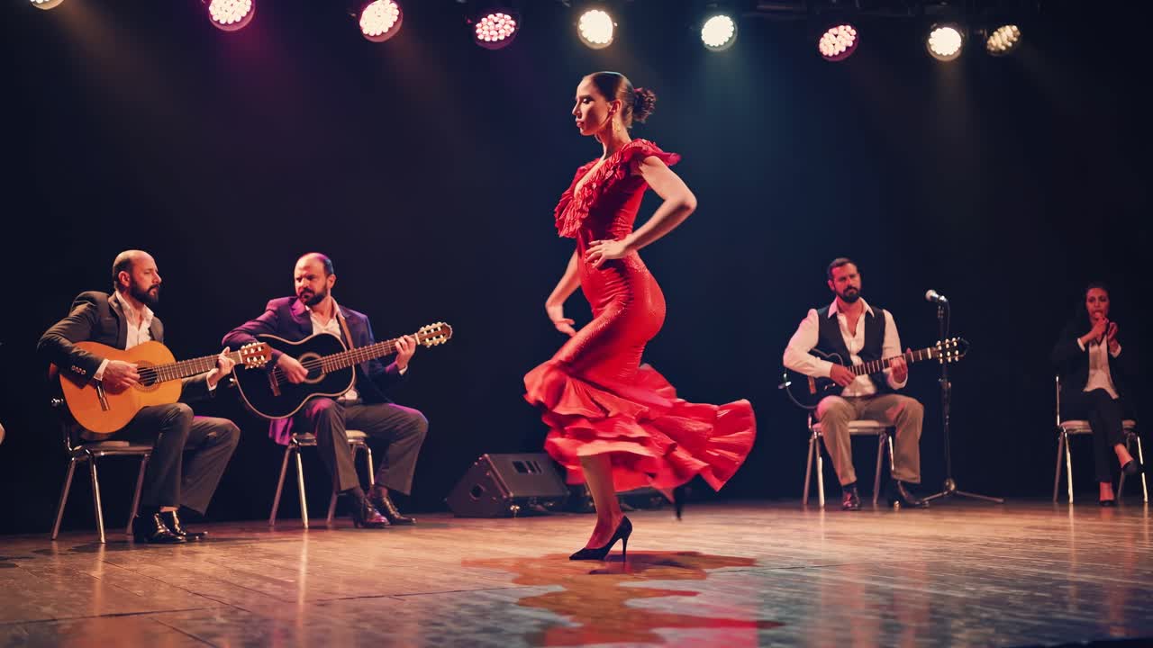 A dynamic video captures a flamenco dancer in a vibrant red dress on stage, shot from a low angle