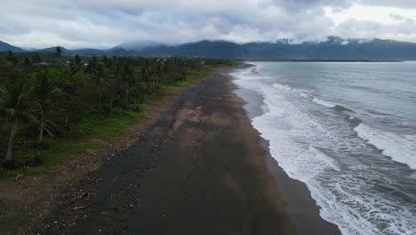 black sand beach with foamy waves in catanduanes, philippines. - aerial shot