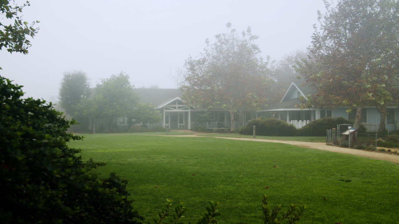 Foggy Landscape with House and Green Lawn