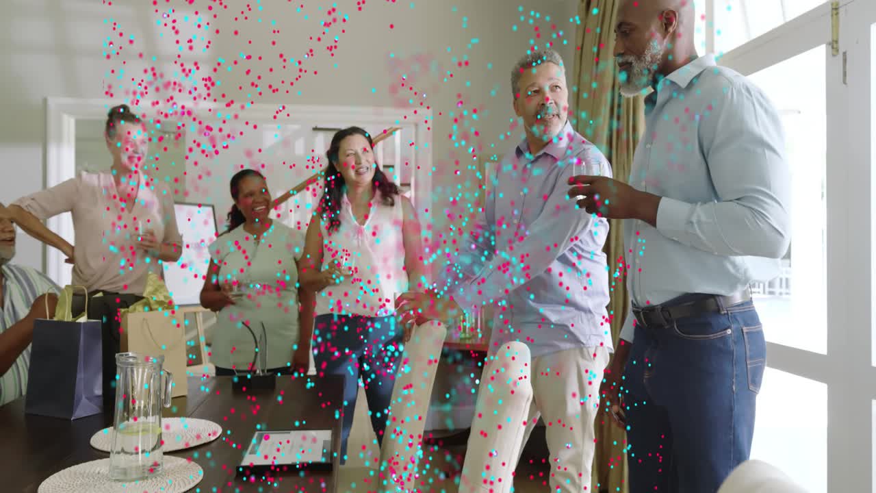 Host gesturing, guests holding drinks at dining table party, animated confetti appearing over group