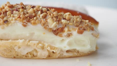 close-up of a delicious eclair with nut topping