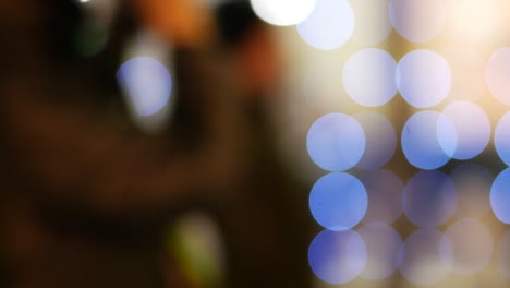 silhouettes of unrecognizable people on abstract christmas background in bokeh