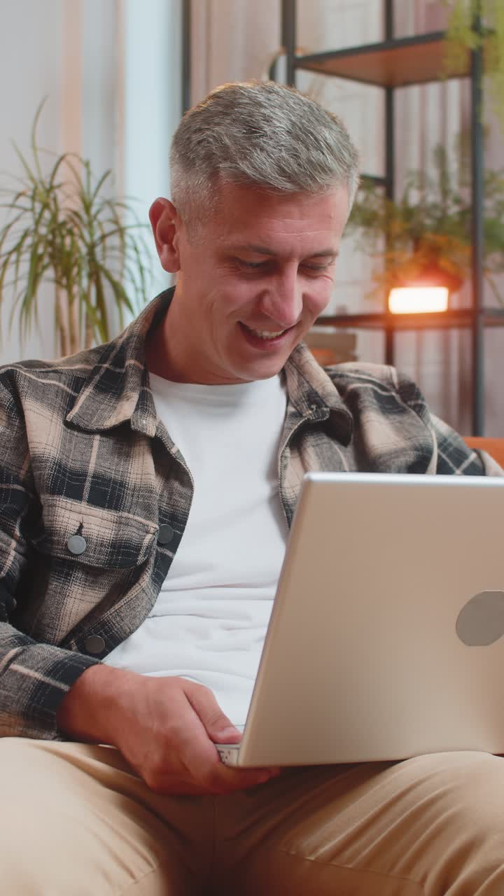 Displeased man use laptop surprised by bad news virus error game fail lottery results at home
