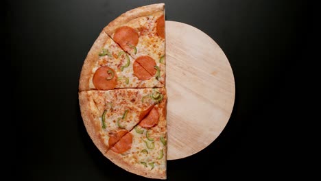 pizza is eaten up on the table, black background
