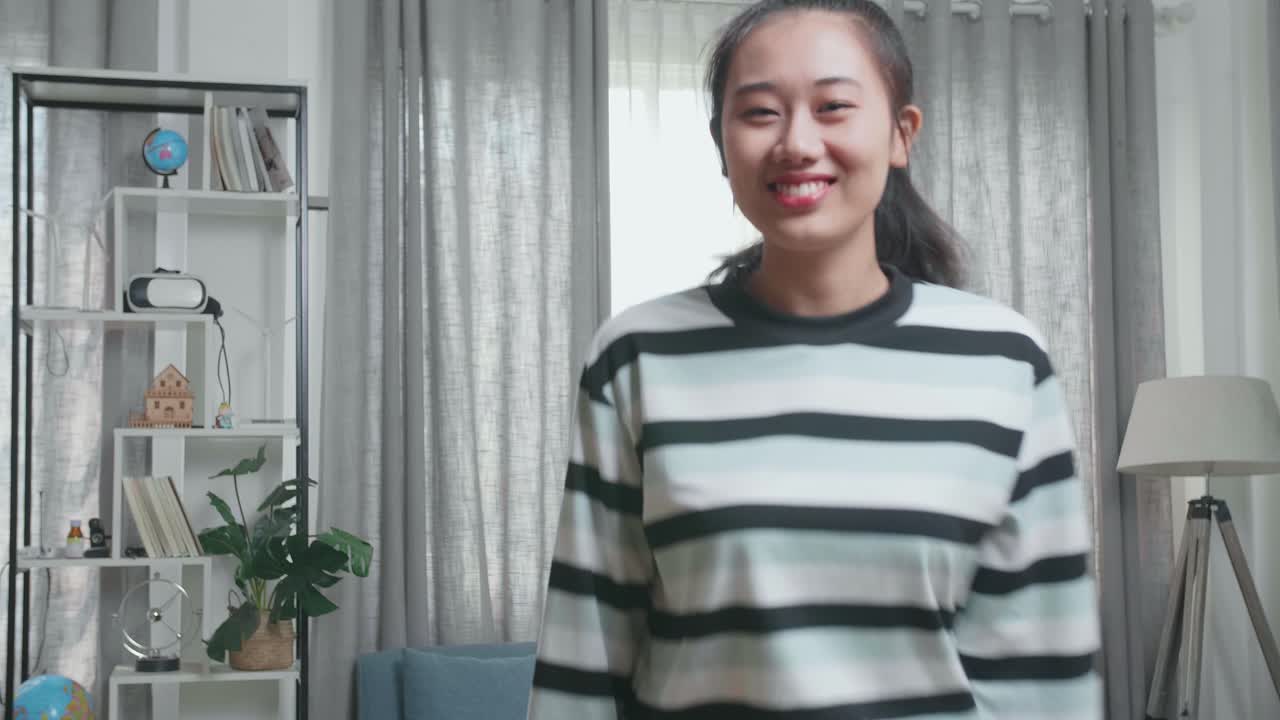 Asian Woman Dancing While Shooting Video Content For Social Networks At Home