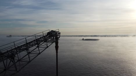 aerial view of a boat sailing down the river on a cold winter morning