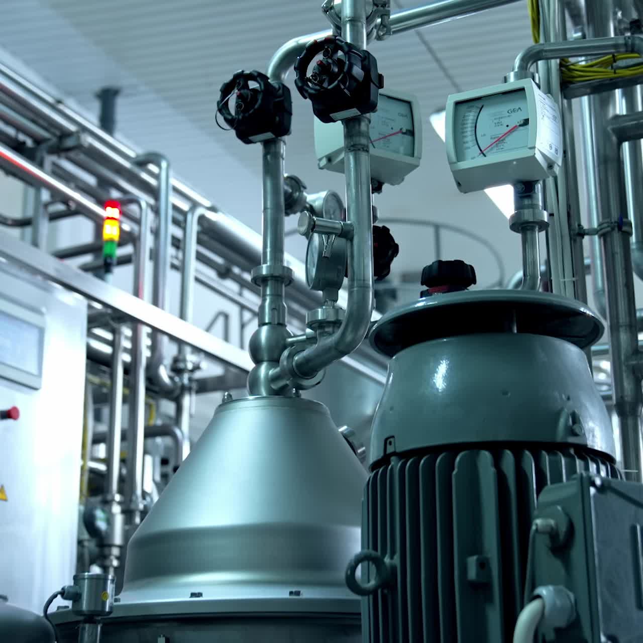 Modern technological equipment at the milk plant. Pipes with sensors leading to the tanks and engine. Close up