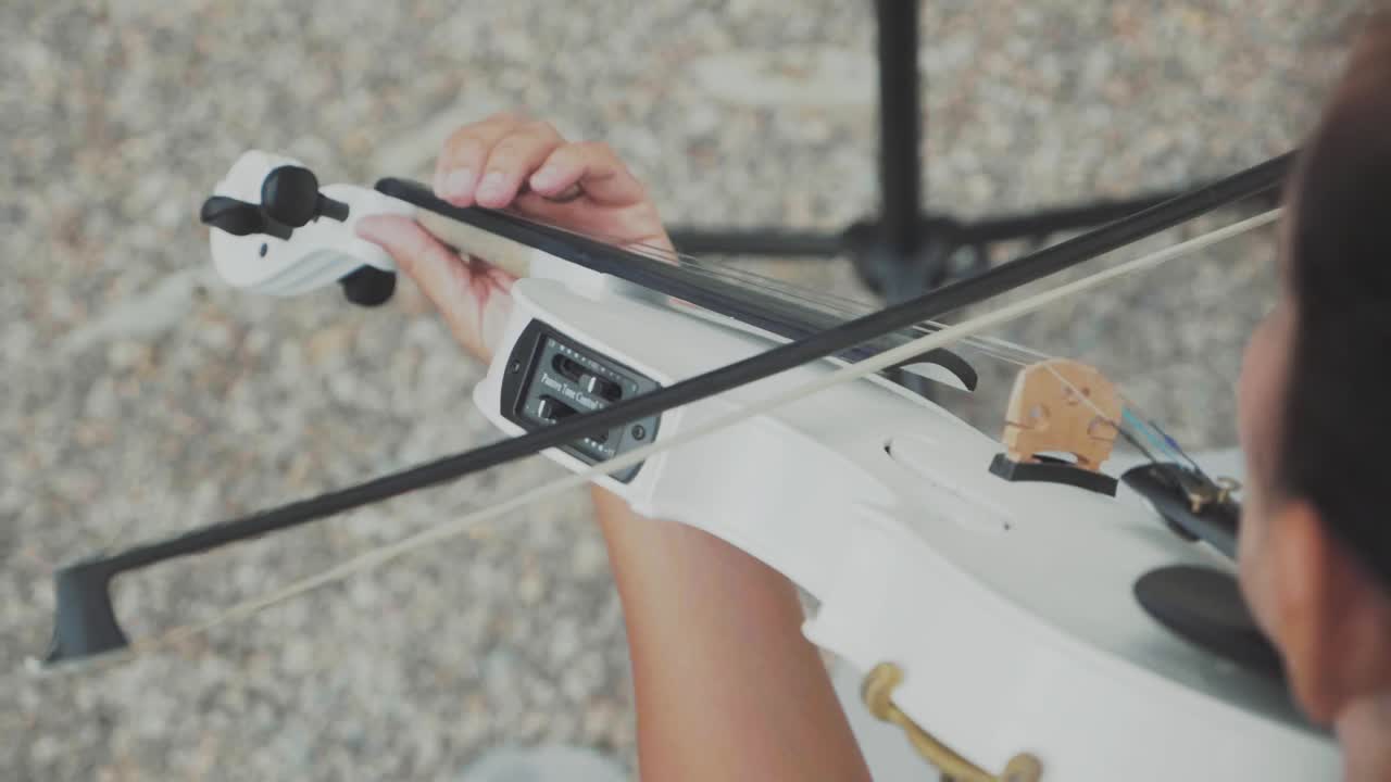 Woman violonist playing in slow motion downward