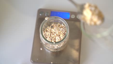 measuring oatmeal on a kitchen scale