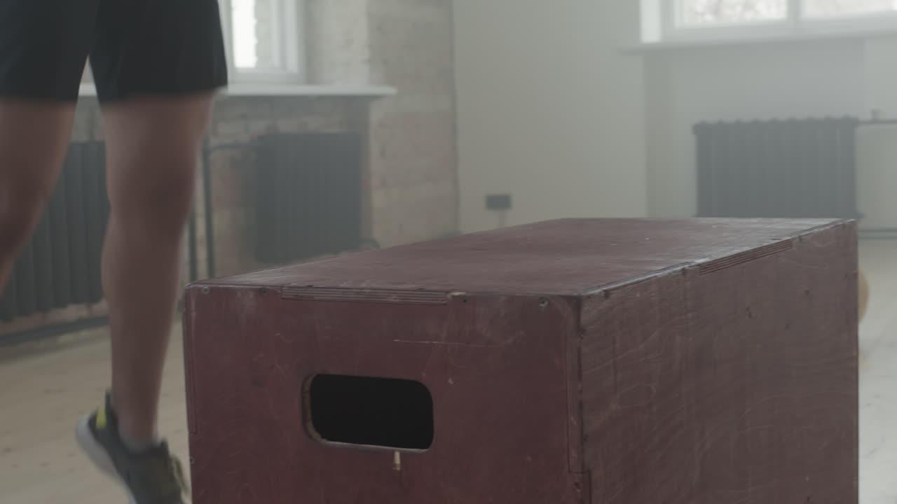 African American Sportsman Jumping Over Box