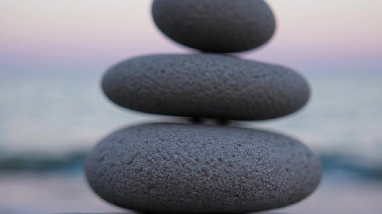 Stacked Stones on Beach at Sunset