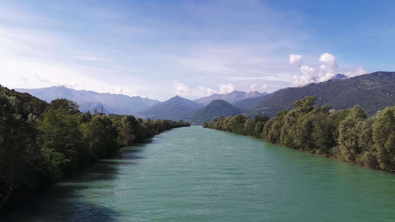 Fly over Adda river towards Lake Como, some birds flying in front