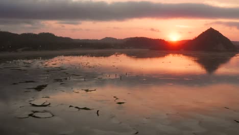 the dry reef of kuta lombok during sunrise, with local people looking for food and seashells