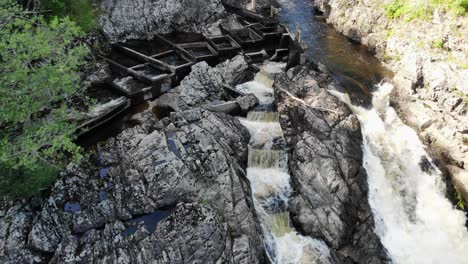 Aerial-drone-shot-of-Salmon-fish-ladder-with-water-running-down-creating-white-milky-foam