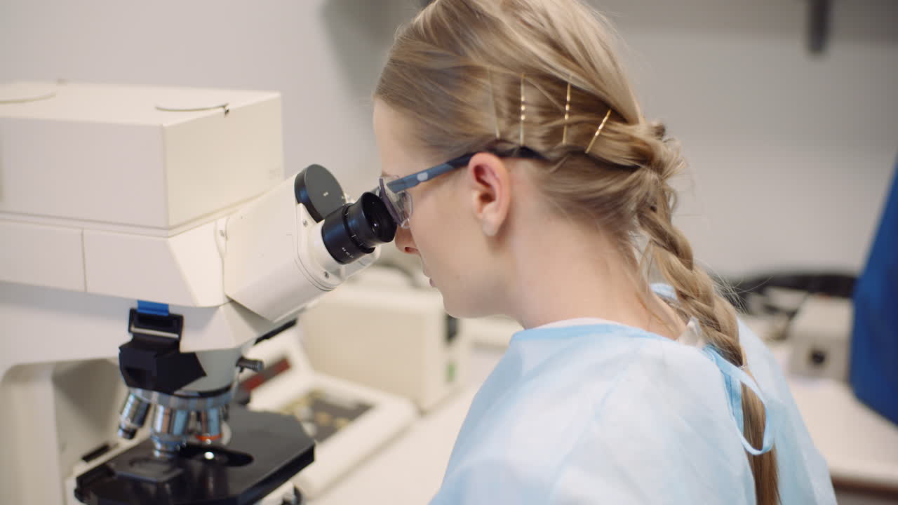 Scientist Examining Bacteria Under Microscope At Laboratory 2