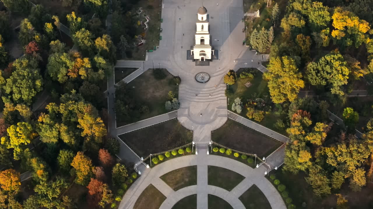 Aerial drone view of Chisinau downtown at sunset. Vertical view of central park, Cathedral, bell tower, Triumphal Arch, Govermental building. Moldova