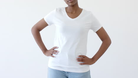 sección media de una mujer afroamericana vestida con una camiseta blanca con espacio de copia en un fondo blanco