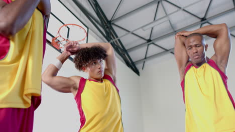 Young-biracial-man-and-African-American-man-stretching-in-a-gym