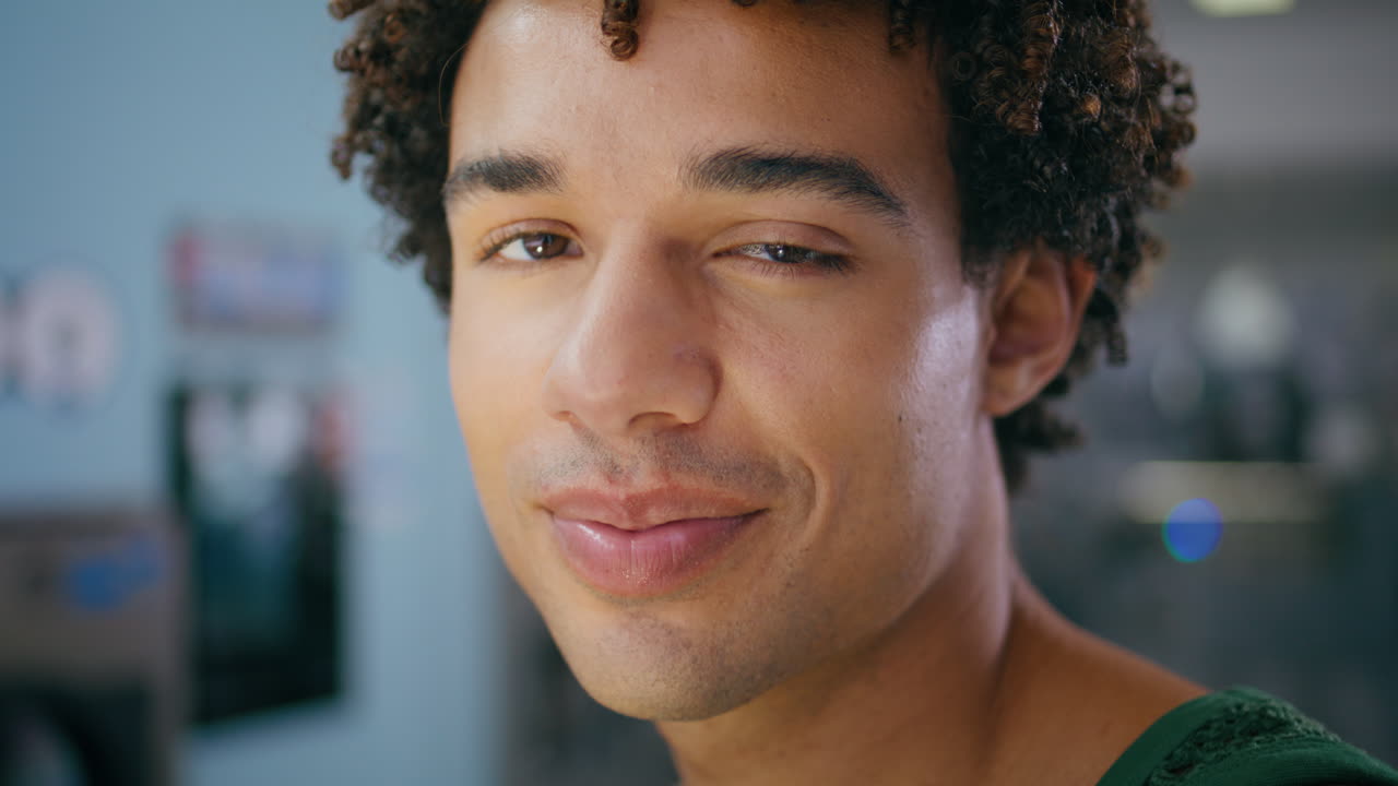 Portrait smiling teenager posing indoors. Handsome  student resting cafe