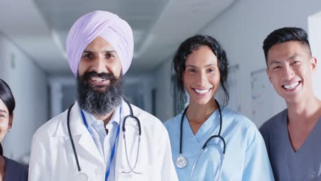 portrait of diverse doctors and nurses smiling in corridor at hospital, in slow motion