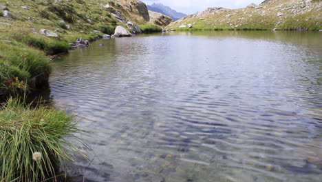 camera movement from the water creek with sky reflect to the alps mountain