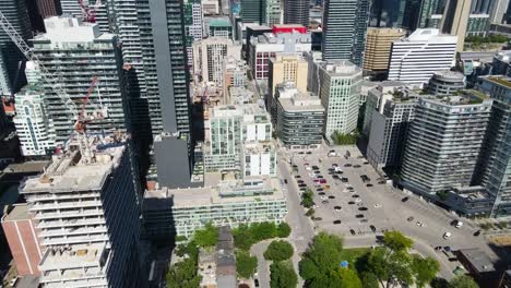 Aerial-view-flying-toward-buildings-in-downtown-Toronto-on-a-spring-day