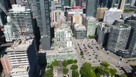 aerial view flying toward buildings in downtown toronto on a spring day