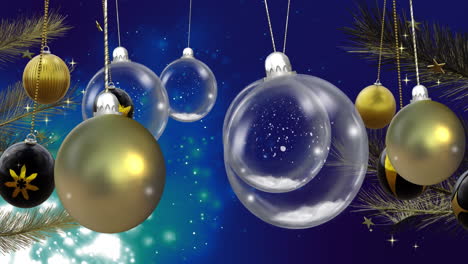 Swinging clear, black and gold christmas baubles over glowing snowflakes on dark blue background