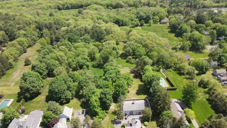 aerial drone shot over hingham, a rural countryside town with trees and fields