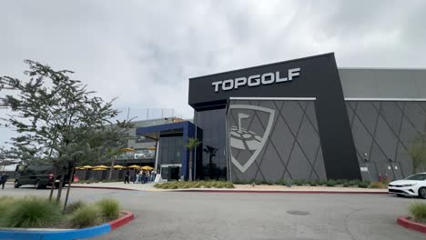the view from the parking lot of a top golf store entrance in los angeles, california.