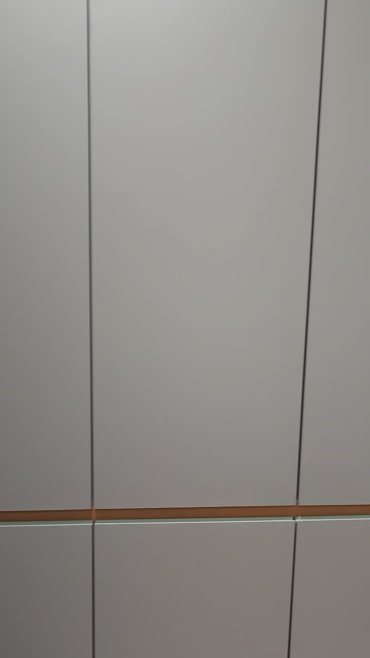 Person Working at a Built-in Desk with Modern Grey Cabinets
