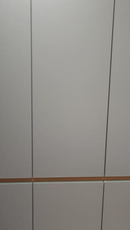 person working at a built-in desk with modern grey cabinets