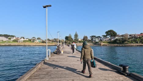 man fishing on a sunny pier