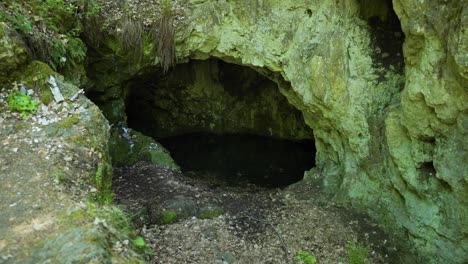 Moving-towards-the-entrance-of-a-natural-cave,-a-a-site-known-as-the-tomb-of-the-Egyptian-goddess-Bastet,-located-on-top-of-Strandzha-Mountain-in-Bulgaria