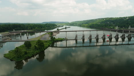 mirror reflections at arkansas river under big dam bridge near cook's landing park in north little rock, arkansas, usa