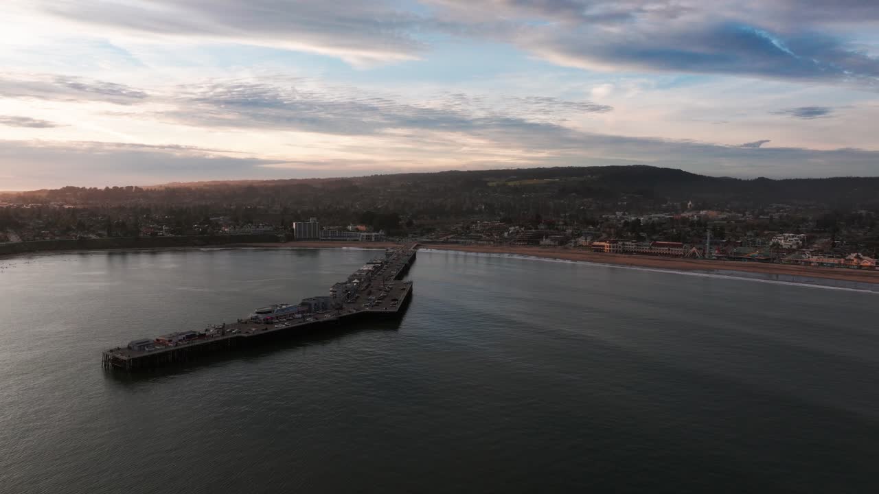 Pull back drone shot of the santa cruz, CA pier and beach area