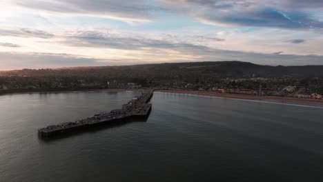 pull back drone shot of the santa cruz, ca pier and beach area