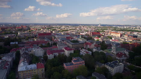 Drone-backwards-shot-over-central-cityscape-of-Cracow-Town-during-sunny-day,Poland