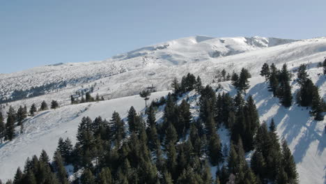 drone shot of snowy peak and ski slope in malyovitsa in bulgaria