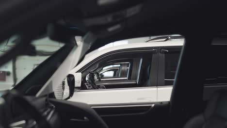 expensive suvs are lined up in a showroom. cars are ready for sale or rent.